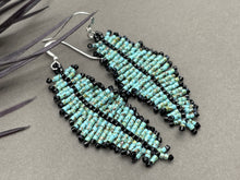 Load image into Gallery viewer, 2.5 inch long seed bead beaded feather earrings in a turquoise green Picasso finish with black accents. hung on sterling silver ear wires