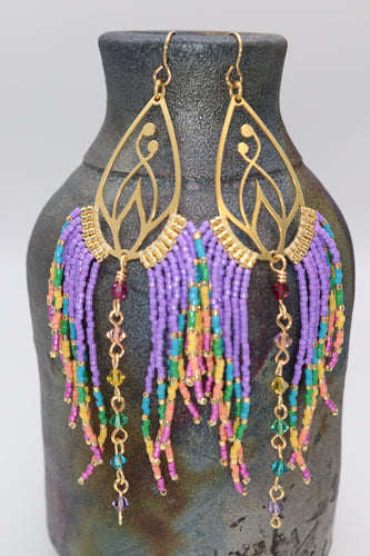 rainbow beaded lotus flower earrings.  Hand beaded in rainbow colors with premium delica seed beads and premium crystals.  Colorful statement earrings