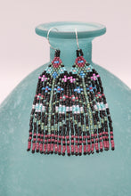 Load image into Gallery viewer, 3 inch long by .75 inch wide seed bead fringe earrings. Handmade. Black base with plum, aqua, pink, and lavender floral pattern with green leaves and stems
